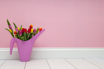 Tulips standing by a wall