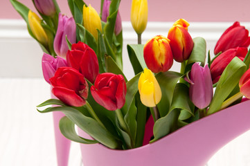 Tulips standing by a wall