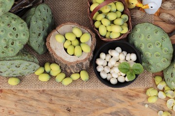 Lotus seeds in nature on wood background.