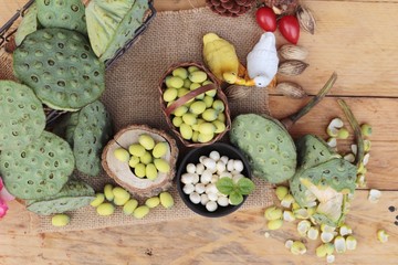 Lotus seeds in nature on wood background.