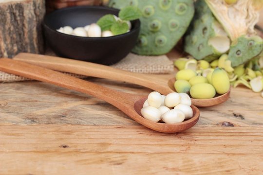 Lotus seeds in nature on wood background.