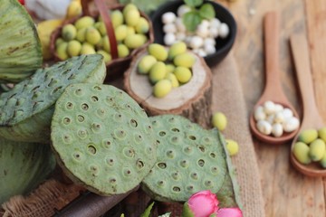 Lotus seeds in nature on wood background.