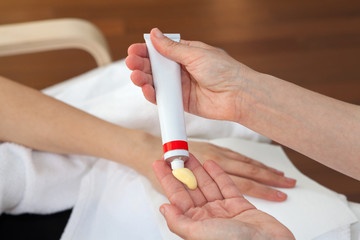 Hand treatment, therapist applying hand cream