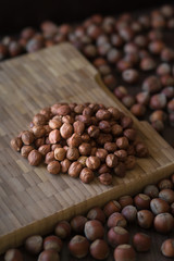 Hazelnuts, filbert on wooden background