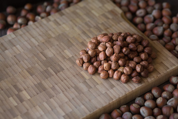 Hazelnuts, filbert on wooden background