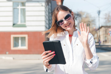 Fototapeta premium smiling girl touching tablet screen
