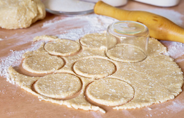 Cooking cottage cheese biscuits. Rolling dough layer. Cutting discs for cookies