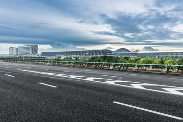 road near by the airport under the cloudy sky