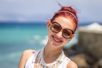 Young Beautiful Lady Sitting on Rock near the Sea, Crete