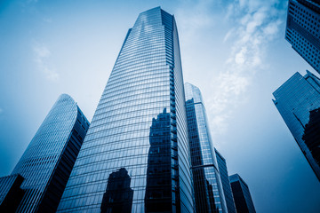 Fototapeta na wymiar Facade of skyscrapers, low angle view,blue toned image.