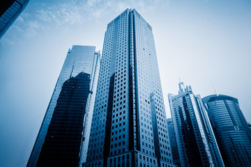 Obraz na płótnie Canvas Facade of skyscrapers, low angle view,blue toned image.