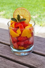 Mango and strawberry fruit salad in a glass cup