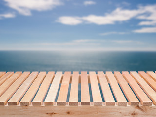 Naklejka na ściany i meble wooden bench with blue sea and blue sky background