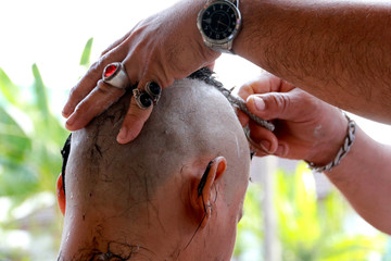 Naklejka premium Culture,male who will be monk,while shaving hair for be ordained to new monk 
