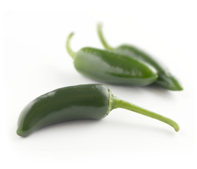 green peppers on a white surface