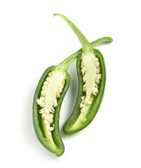 green pepper cut on a white surface