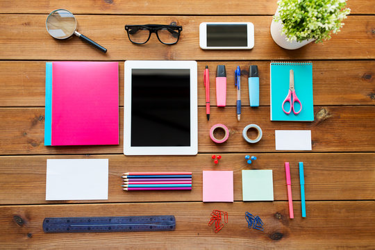 close up of school supplies and tablet pc