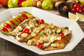 Fish grilled with vegetables in the plate.
