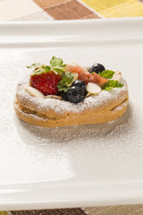 fresh fried pumpkin churros with red fruits on plate