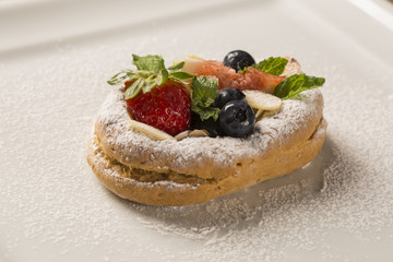 fresh fried pumpkin churros with red fruits on plate