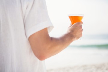 Man drinking cocktail on the beach