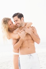 Happy couple embracing on the beach