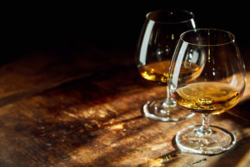 Close up of two bourbon filled glasses on table