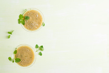 Fresh banana cocktail with mint on the wooden background