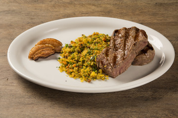 Fillet mignon grilled on plate with crumbs and bacon