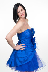 Cheerful woman portrait in blue dress, attractive caucasian