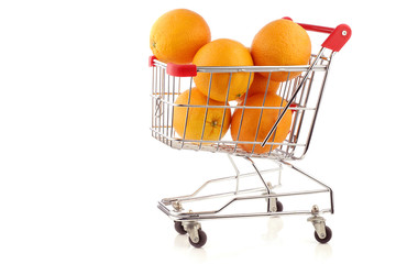 fresh oranges in a shopping cart on a white background