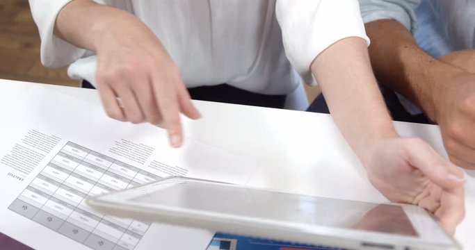 Businessman and woman working on tablet