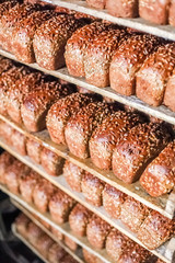 Freshly baked bread stacked and ready for packaging at factory