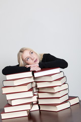 student relaxing on red books