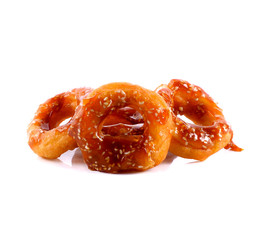 Ring-shaped cracknels with sesame seeds on white background