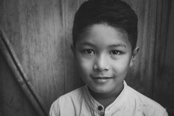 scared and alone, young Asian child who is at high risk of being bullied, trafficked and abused,...