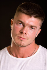 Obraz premium Bodybuilder showing his back and biceps muscles, personal fitness trainer. Strong man flexing his muscles