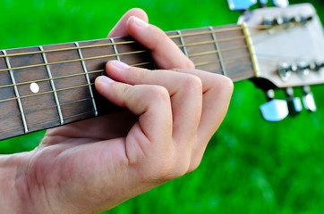 Man's hand and guitar