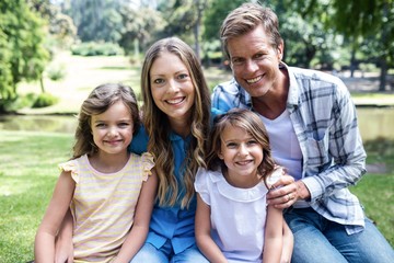 Happy family sitting in the park 