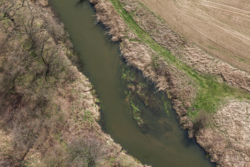 aerial view of  over the  river and harvest fields