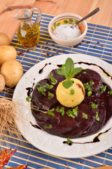 White dish with sliced beetroot and mint