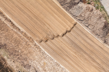 Aerial view of the  earth mover tracks on sand
