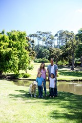 Happy family standing in the park 