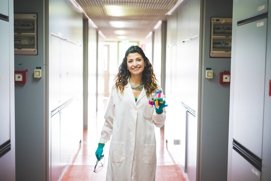 Female scientist walking in laboratory of material science and nanotechnology