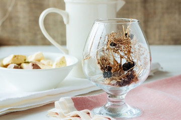 Glass with dried berries and grass
