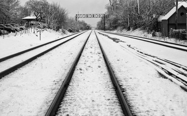 Looking down Winter train tracks in snow