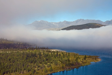 A cloud of mist over a mountain lake. Lake Darpir. Yakutia. Russia.