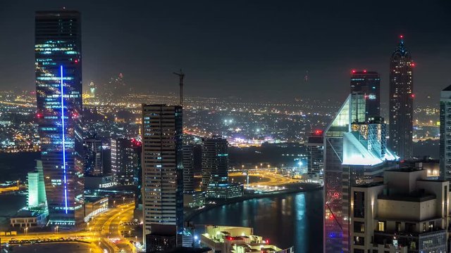 Scenic aerial view of a big modern city at night timelapse. Business bay, Dubai, United Arab Emirates.