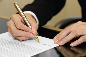 businessman hand signing a contract paper