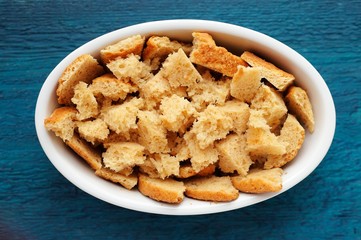 Panettone torn in pieces for homemade pudding on navy blue backg